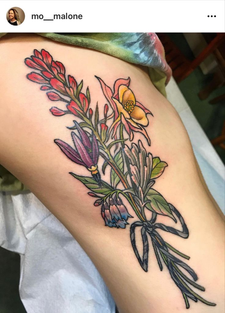 a woman's thigh with flowers on it