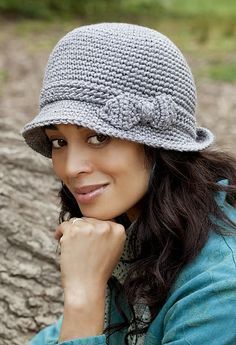 a woman wearing a gray crochet hat