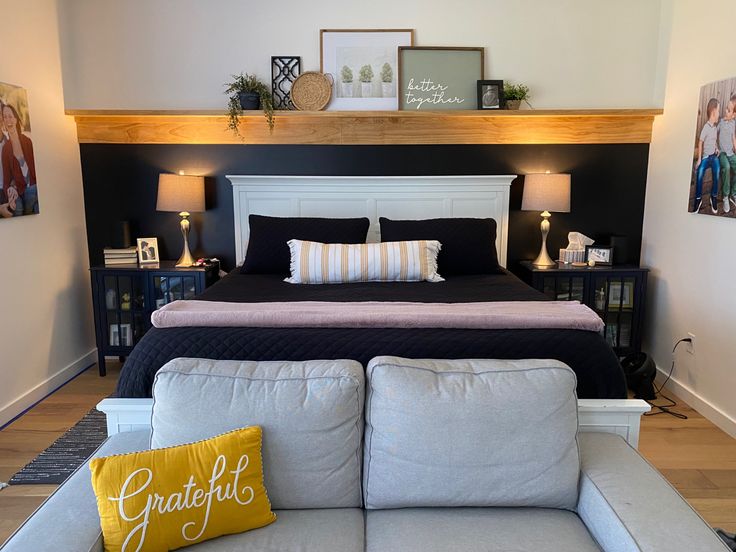 a large bed sitting next to a white couch in a bedroom