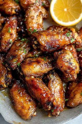 chicken wings with lemon wedges and parsley