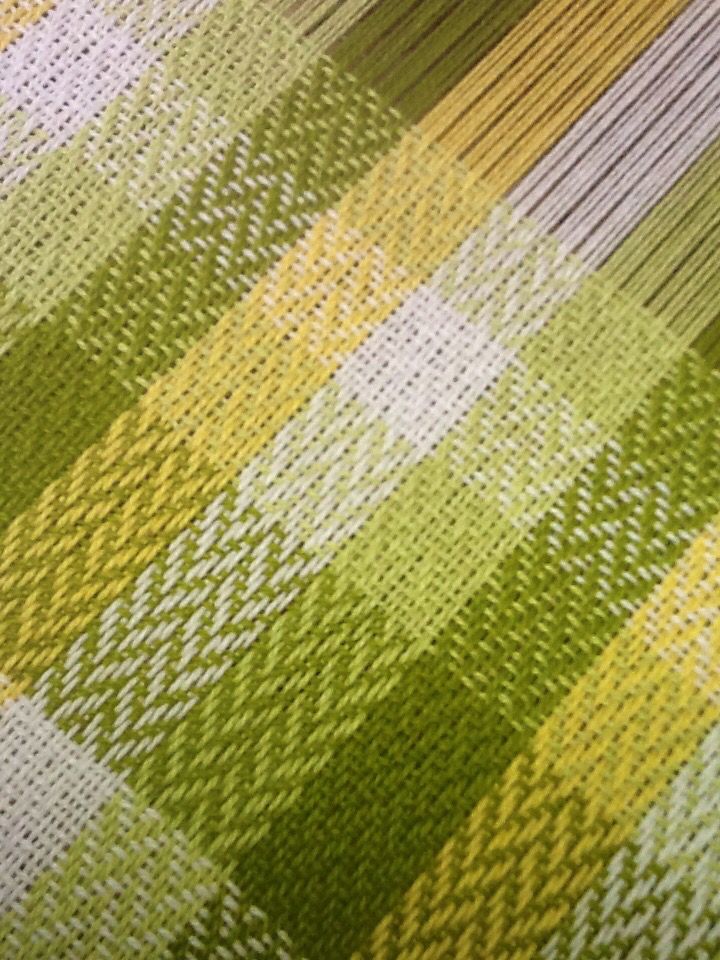 a close up view of a green, yellow and white checkered fabric