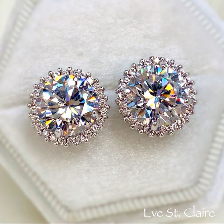 Stunning Eve St. Claire Stud Earrings ! Beautiful Synthetic Diamond Halo Studs Super Sparkly 6.0 Ct Total Weight For Both Earrings 14k Gold Over Sterling Silver 925 & Stamped Solid Precious Metal Perfect For Bridal & Wedding Or Work & Play ! These Classy Earrings Work Around The Clock Velvet Box Color : D Clarity : Vvs1 Creation : Synthetic Diamond Main Stone Shape : Round Brilliant Size : 9 Mm Stone - 3 Ct Each Secondary Stones : Round Total Ct Weight : 6.0 Ct Finish : 14k White Gold My Other J Opal Art, St Claire, Classy Earrings, Band Necklace, Synthetic Diamond, Engagement Sets, Earrings Diamond, White Gold Earrings, Platinum Ring