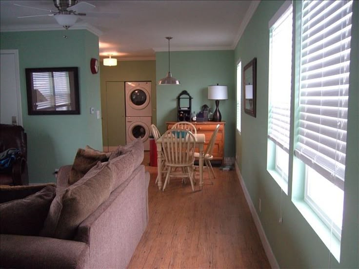 a living room filled with furniture next to a wooden floor