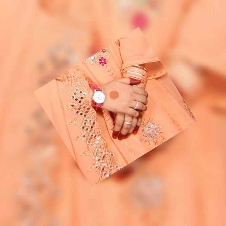 a woman's hand holding an orange purse