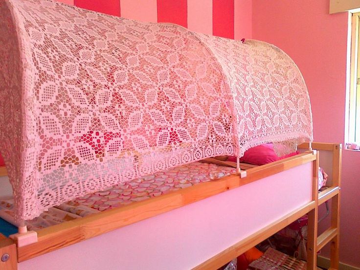 a pink crocheted bed frame in a room