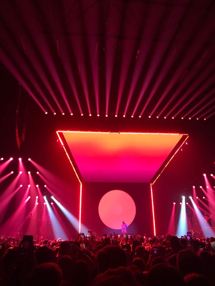 the stage is lit up with red and pink lights