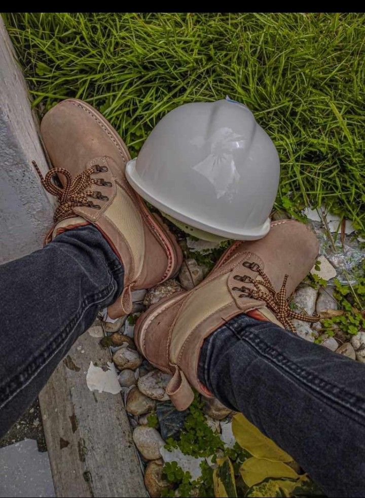 a pair of shoes and a hard hat on the ground