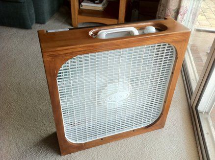 an old radio sitting on the floor next to a window