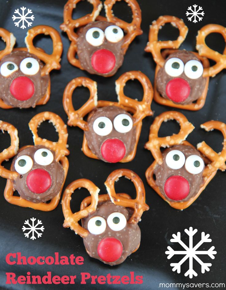 chocolate reindeer pretzels on a black plate with snowflakes