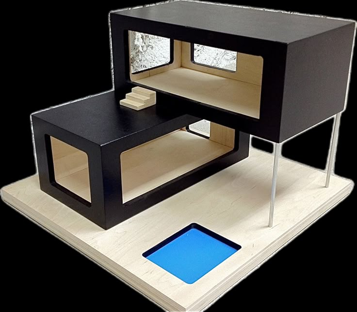 a small black and white table with a blue square in the center on top of it