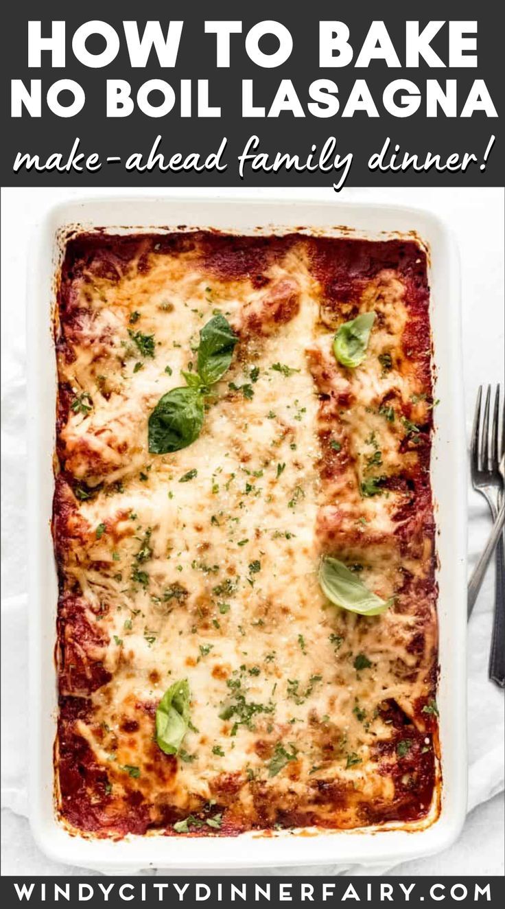 the best easy lasagna recipe in a white casserole dish with basil leaves on top