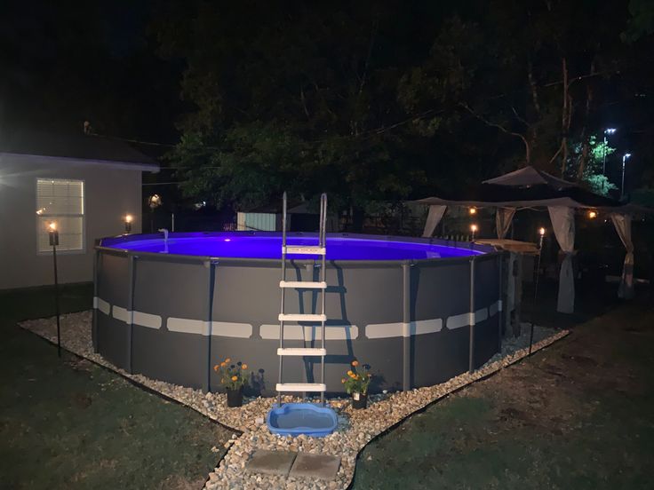 an above ground swimming pool at night