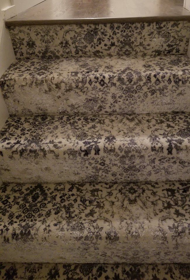 the stairs are covered with black and white carpet