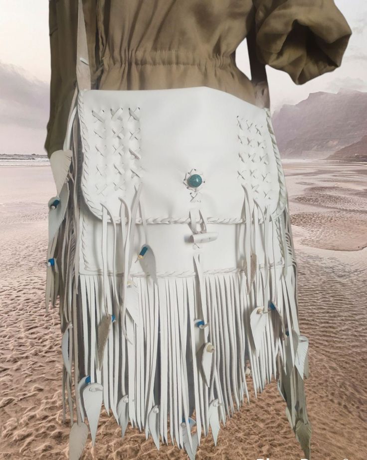 White Top Cow Leather. Native American inspired for the women of today! Timeless-soft touch..the Native look compose a perfect image for both professional space an a evening or morning event in which you want to impress! Ideal for traveling..Beach..Partys..Festival. Crossbody or Shoulder Bag decorated with turquoise stone,white long Fringes and laces- gives to this Bag a unforgetable look once seeing! It has the unique look of a handmade work. Make to last forever. Will become better with time. White Crossbody Shoulder Bag For Festival, White Bohemian Leather Bags, Bohemian White Leather Bags, Hippy Party, Traveling Beach, Handmade Leather Purse, Top Cow, Leather Fringe Bag, Beach Festival