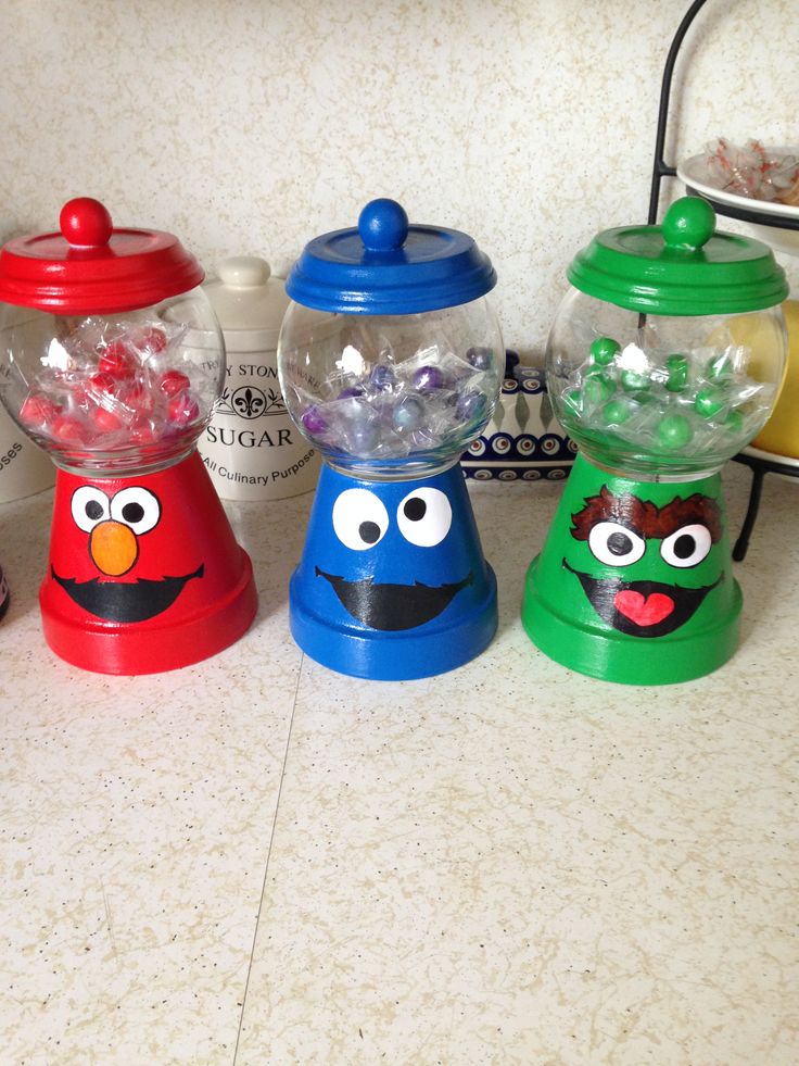 four plastic candy dispensers sitting on top of a counter