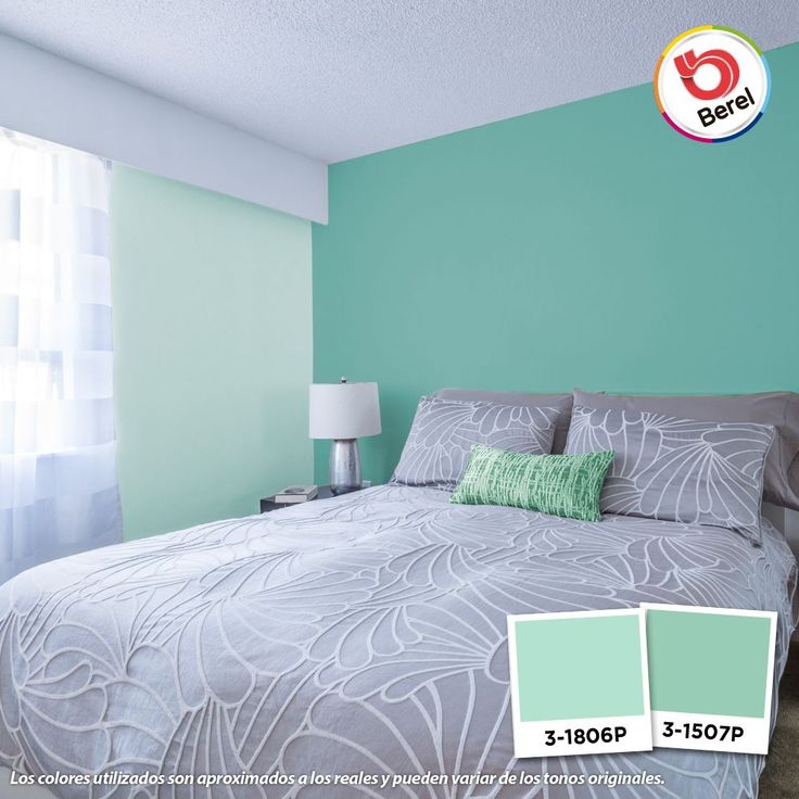 a bedroom with blue and green walls, white curtains and a bed in the corner