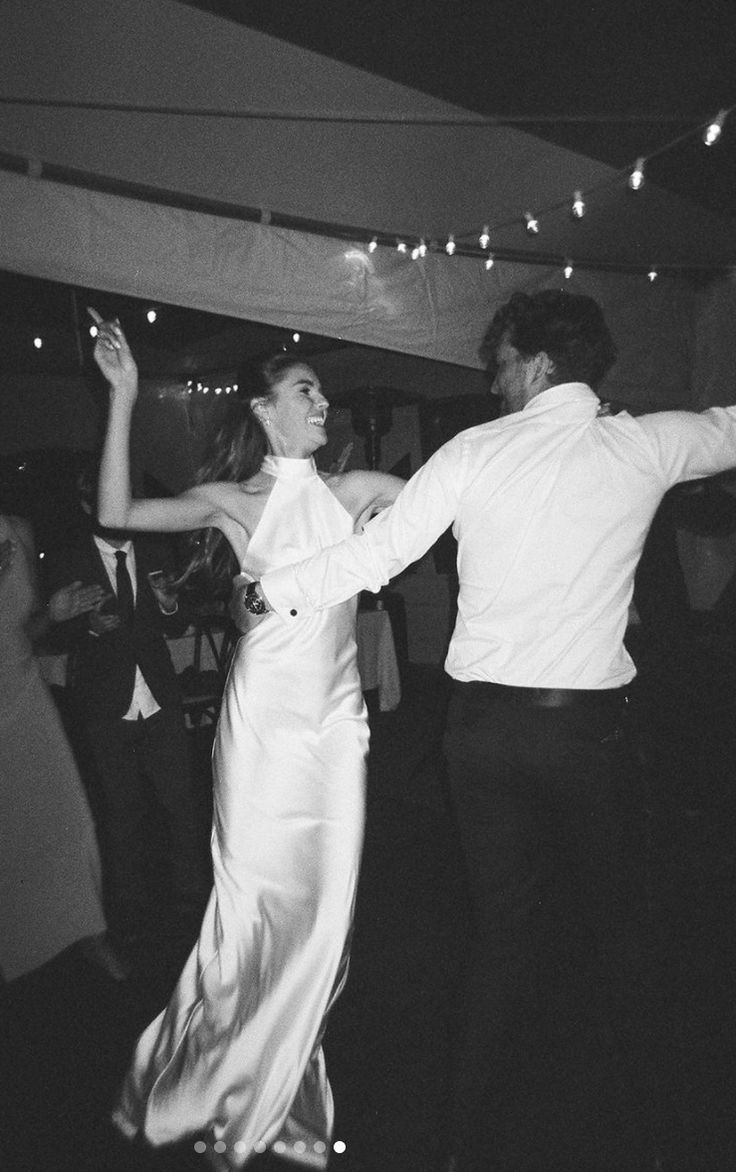 a man and woman dancing at a party