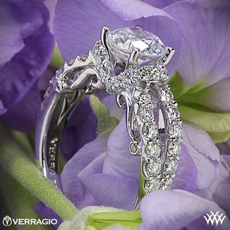 a close up of a diamond ring on purple flowers