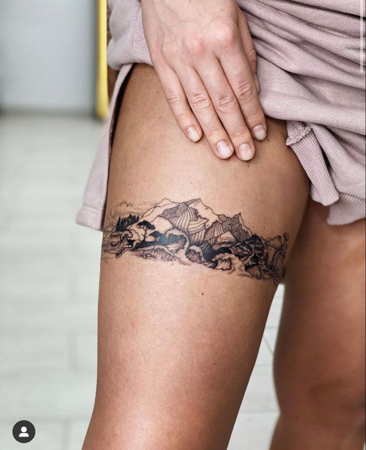 a woman with a tattoo on her thigh