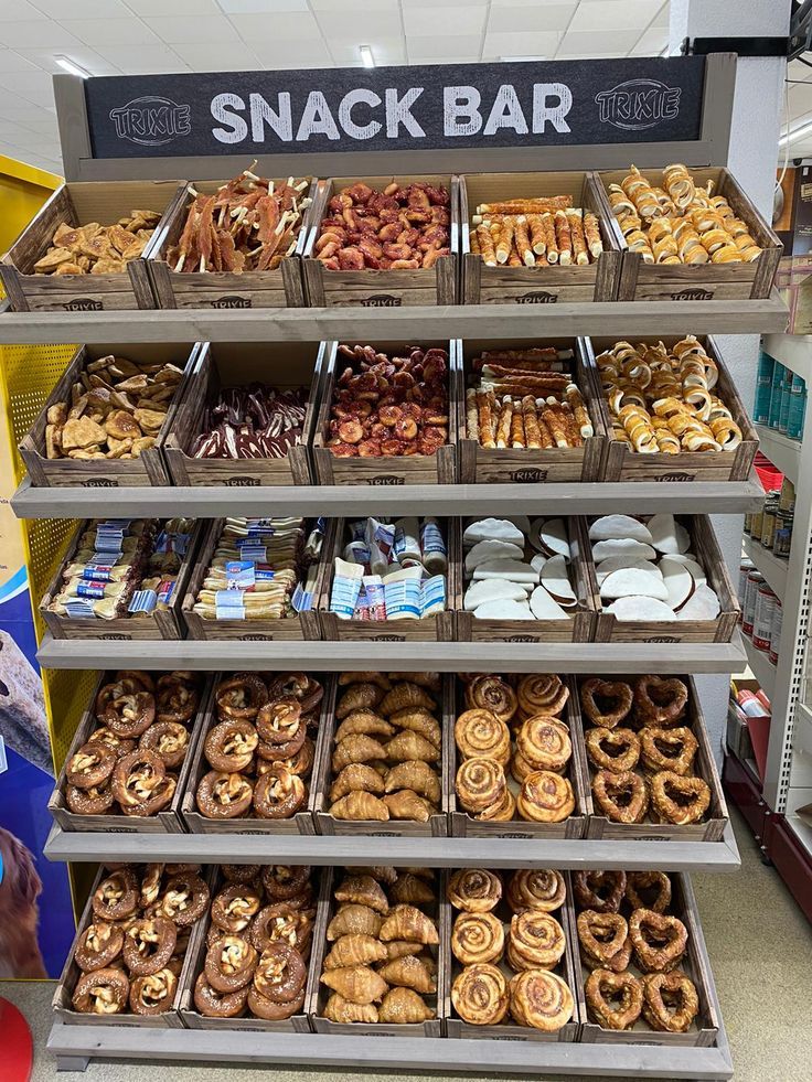 a display case filled with lots of different kinds of doughnuts and pastries