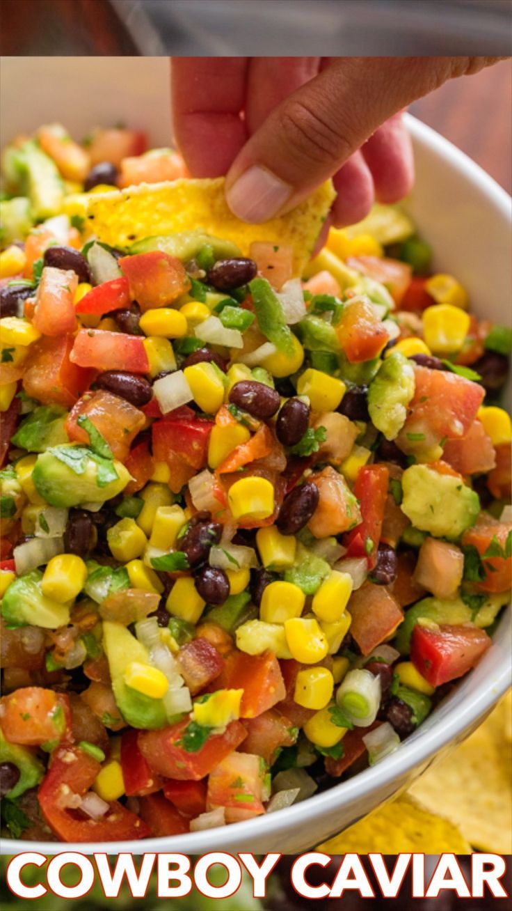 a bowl filled with black beans, corn and guacamole