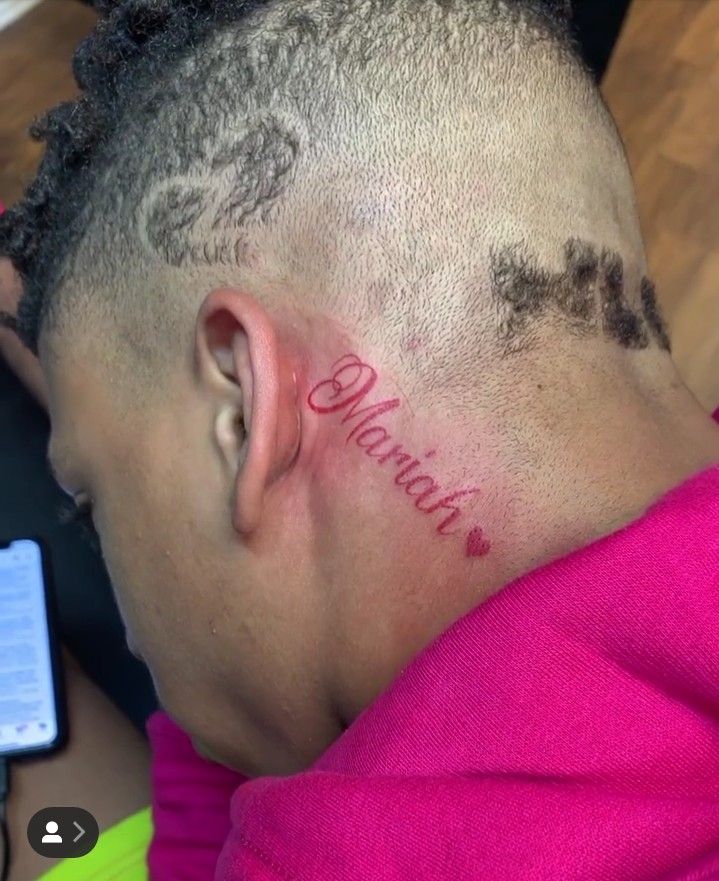 a man with a tattoo on his neck that reads,'grandma'in cursive writing