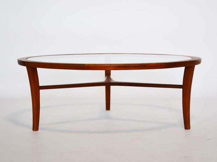 an oval coffee table with glass top and wooden frame, on a plain white background