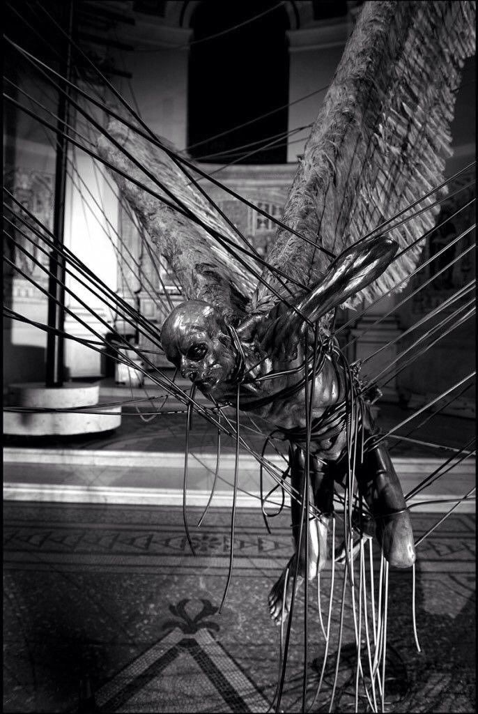 black and white photograph of wires in front of a building