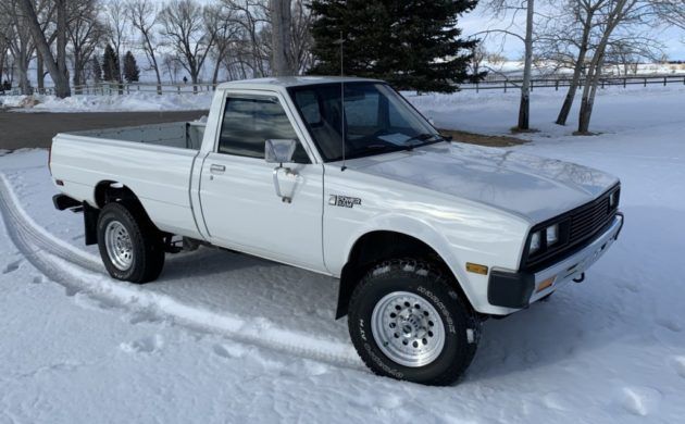 a white pick up truck parked in the snow