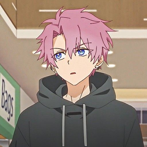 a man with pink hair and blue eyes wearing a black hoodie in front of a store