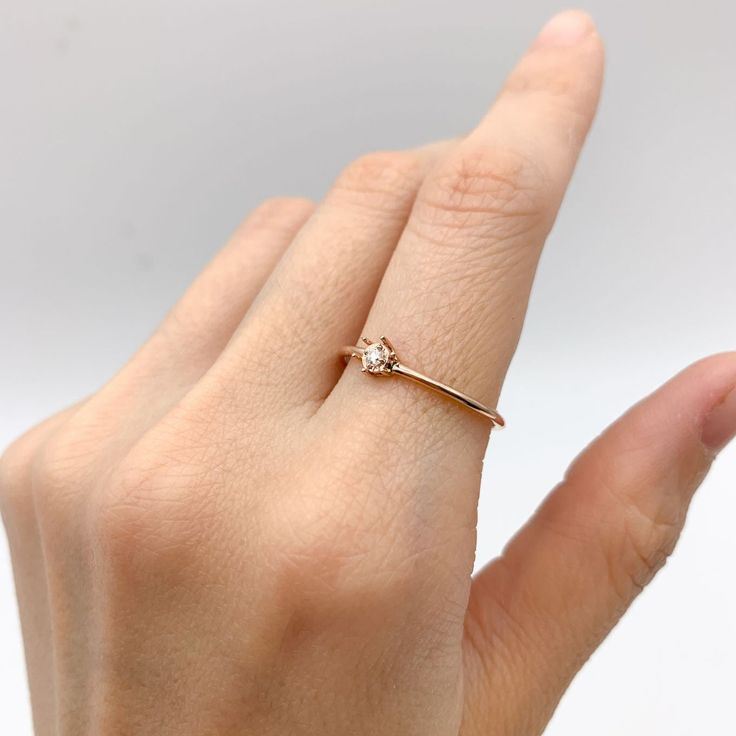 Dainty Diamond Rose Gold Ring set with Natural Diamond, size 2 millimeters diameter, 0.6 Carats.Solid 14k Rose Gold ☞ made to last.Click here for ☞ Solid Gold CollectionDiamond Details:• CERTIFIED Natural Diamond• Weight: 0.6 Carats• Dimensions: 2mm• Color: G• Clarity: I1• Cut: Very GoodSolid Gold Details:• 1 gram of 14k Solid Rose Gold• Dimensions: Band width ≈ 1mm, thickness ≈ 1mm• Lasts a lifetime - Perfect for everyday use (won’t tarnish)!*Final weight & dimensions depending on the chosen ri 14k Rose Gold Stackable Promise Rings, 14k Rose Gold Stackable Rings With Brilliant Cut, 14k Gold Rose Flower Ring Gift, Promise Ring In Rose Gold With Single Diamond, Rose Gold Solitaire Stackable Promise Rings, Solitaire Stackable Rose Gold Rings For Promise, Rose Gold Promise Ring With Single Diamond, Rose Gold Single Diamond Promise Ring, 14k Rose Gold Stackable Rings