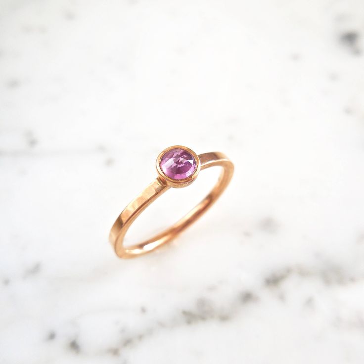 A sweet pink rose cut sapphire in a timeless bezel with a flat 14k rose gold flat band. An everyday piece, in addition to, stacking with other rings for a unique, bold look. genuine pink Sapphire Magenta/Pink Sapphire - Rose Cut faceted sapphire 4 mm round Flat Band Recycled 14 k Rose Gold Ready to ship in Size 7 - Sizable, please message us for a quote. :: please message us for any specifications, time frames, and or change of address. This ring can also be hammered and/or have a matte finish. Pink Ruby Ring With Bezel Setting In 14k Gold, Rose Gold Stackable Rings With Bezel Setting, Pink Bezel Set Stackable Rings For Anniversary, Modern Rose Gold Rings With Bezel Setting, Everyday Rose Gold Stackable Rings With Bezel Setting, Rose Gold Solitaire Pink Sapphire Jewelry, 14k Rose Gold Stackable Rings With Bezel Setting, Pink Round Band Jewelry With Bezel Setting, Pink Jewelry With Bezel Setting And Round Band