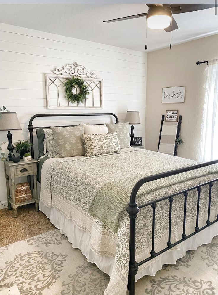 a bedroom with a bed, nightstands and mirror in it's centerpiece