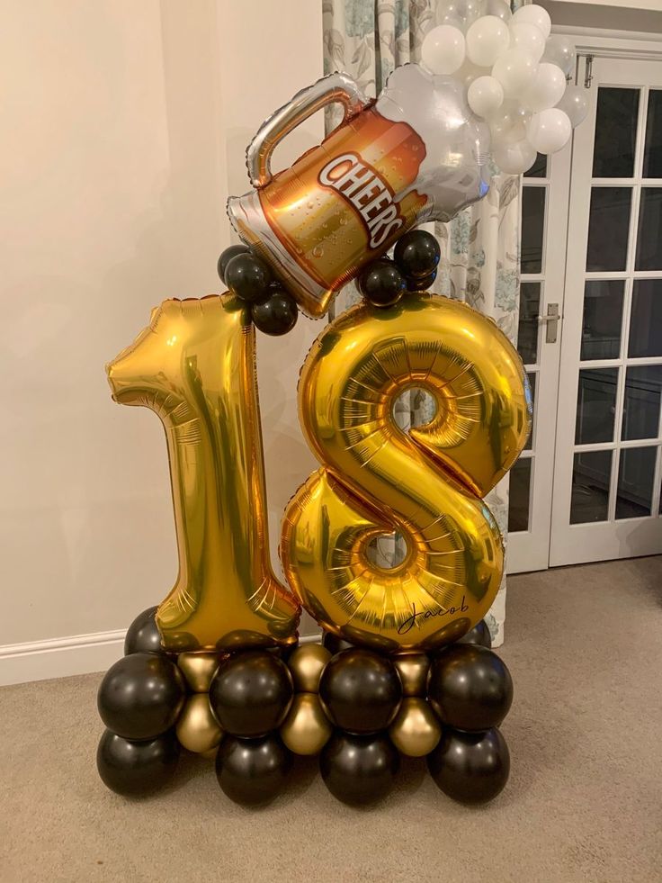 a balloon shaped like the number twenty eight with a can of soda and balloons on top