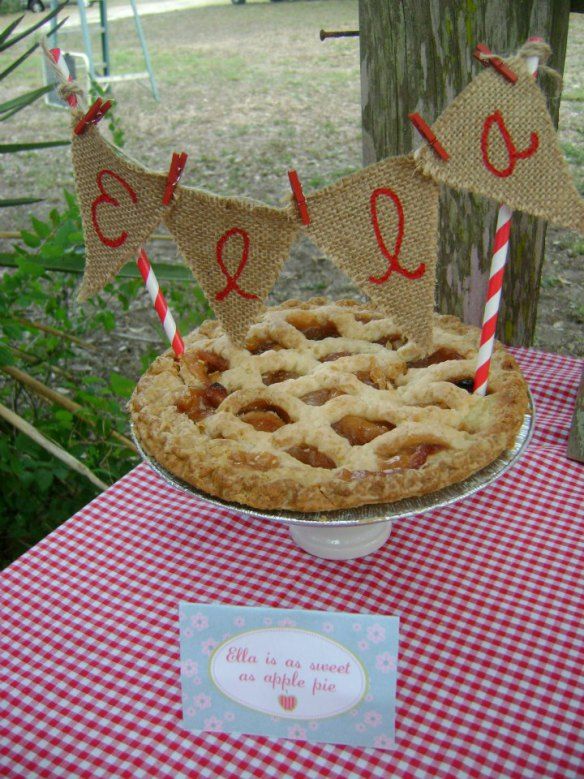 a pie sitting on top of a red and white checkered tablecloth covered table