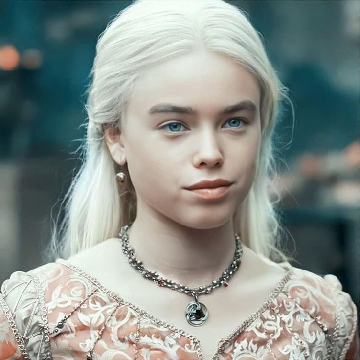 a woman with white hair and blue eyes wearing a necklace in the movie game of thrones