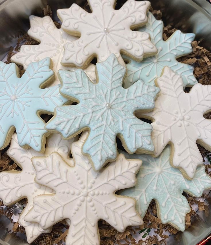 snowflake cookies are arranged in a bowl