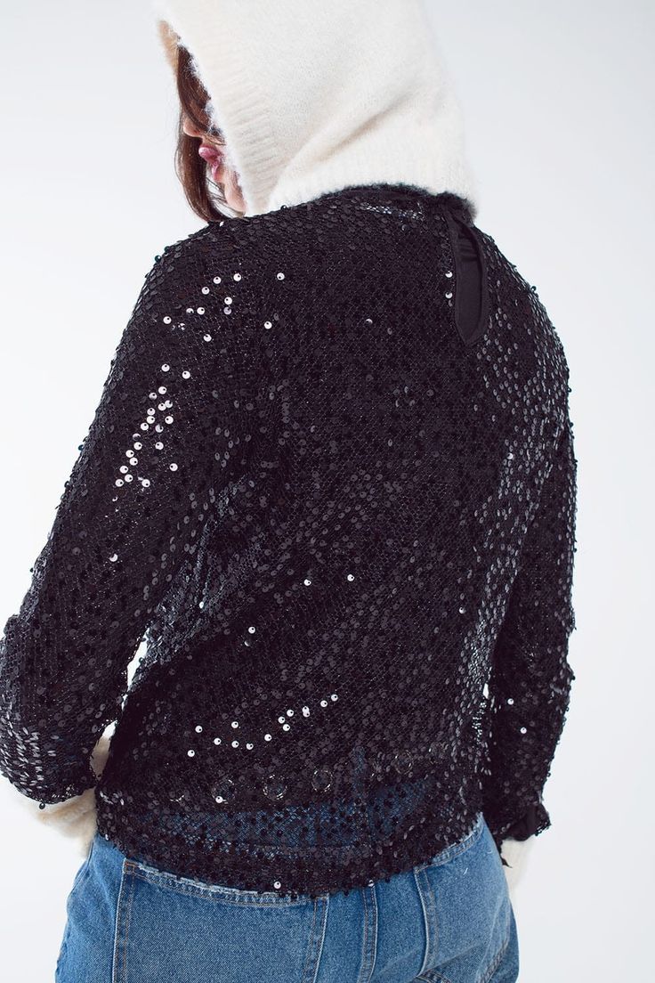 Introducing our Long Sleeve Glitter Top in Black, a dazzling and versatile party piece that's sure to make you shine at festive gatherings, especially during Christmas and New Year's Eve. This black glitter top is designed to add a touch of glamour and style to your wardrobe, and here's why it's a must-have:  This amazing party top is adorned with a multitude of glitters, ensuring you'll be the center of attention wherever you go. With long sleeves, it's the perfect choice for celebrating special occasions during the holiday season, adding an extra layer of elegance and warmth to your outfit.  The slim fit of this top not only enhances your silhouette but also adds a touch of sophistication to your look. The embroidered detail and sequins on this top make it a standout piece that's perfect Black Glitter Top, Long Sleeve Sequin Top, Glitter Top, Long Sleeve Sequin, Style Party, Party Tops, Sequin Top, Party Looks, Black Glitter