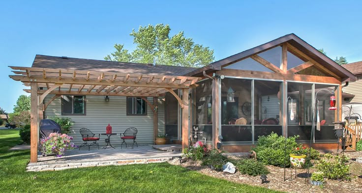 a house with a covered patio in the front yard