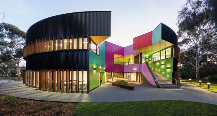 an unusual building with multicolored walls and steps leading up to the top floor