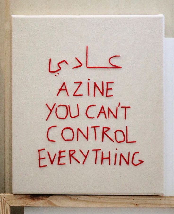 a white sign with writing on it that says azine you can't control everything