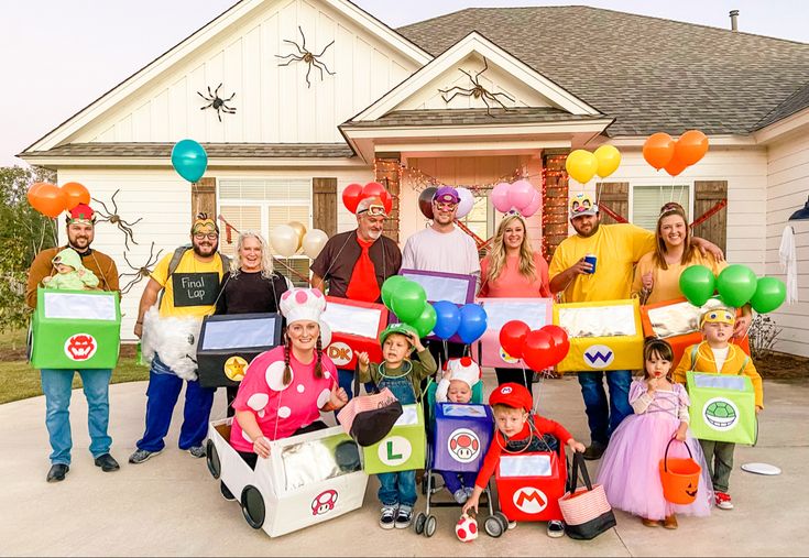 a group of people standing in front of a house with balloons and costumes on their heads