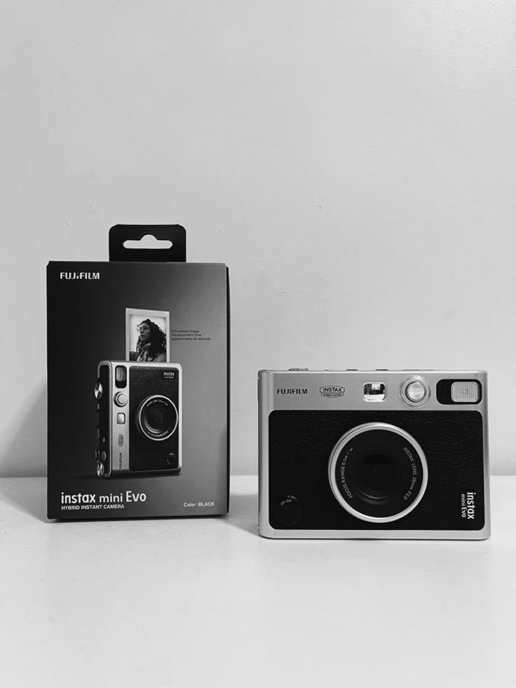 a photo of a film camera, the instax mini evo Instax Evo Camera, Polaroid Mini Evo, Best Disposable Cameras, Instax Mini Evo Camera Aesthetic, Fujifilm Instax Evo, Fujifilm Instax Mini Evo Aesthetic, Instax Mini Evo Photo, Insta Mini Evo, Instead Mini Evo