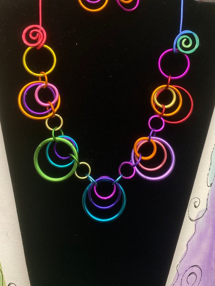 A rainbow of color in circles make up this fun and funky necklace.  Length is about 20 inches and the closure is looping the ring on the side over the aluminum swirl.  photo is an example.  Yours will be in random  multi colors.   earrings are sold separate.  Check listings Hoop Necklace, Funky Necklace, Multicolor Jewelry, Rings Necklace, Crafty Ideas, A Rainbow, Necklace Length, Ring Necklace, Multi Colored