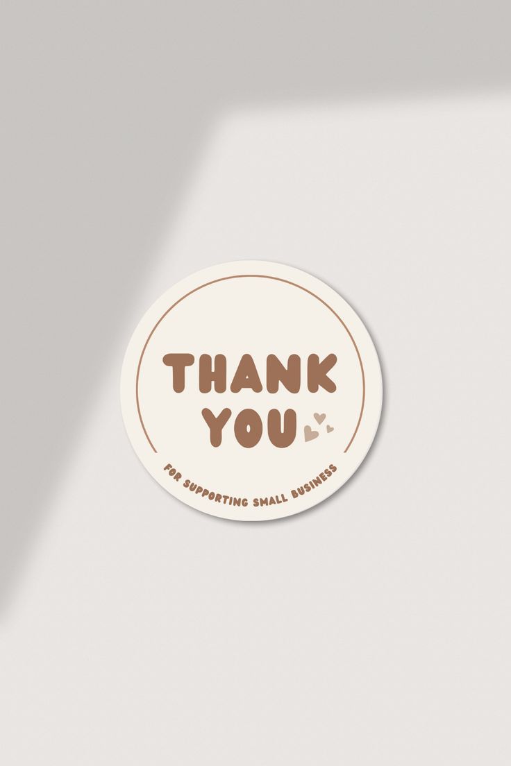 a sticker with the words thank you in brown and white on it's side