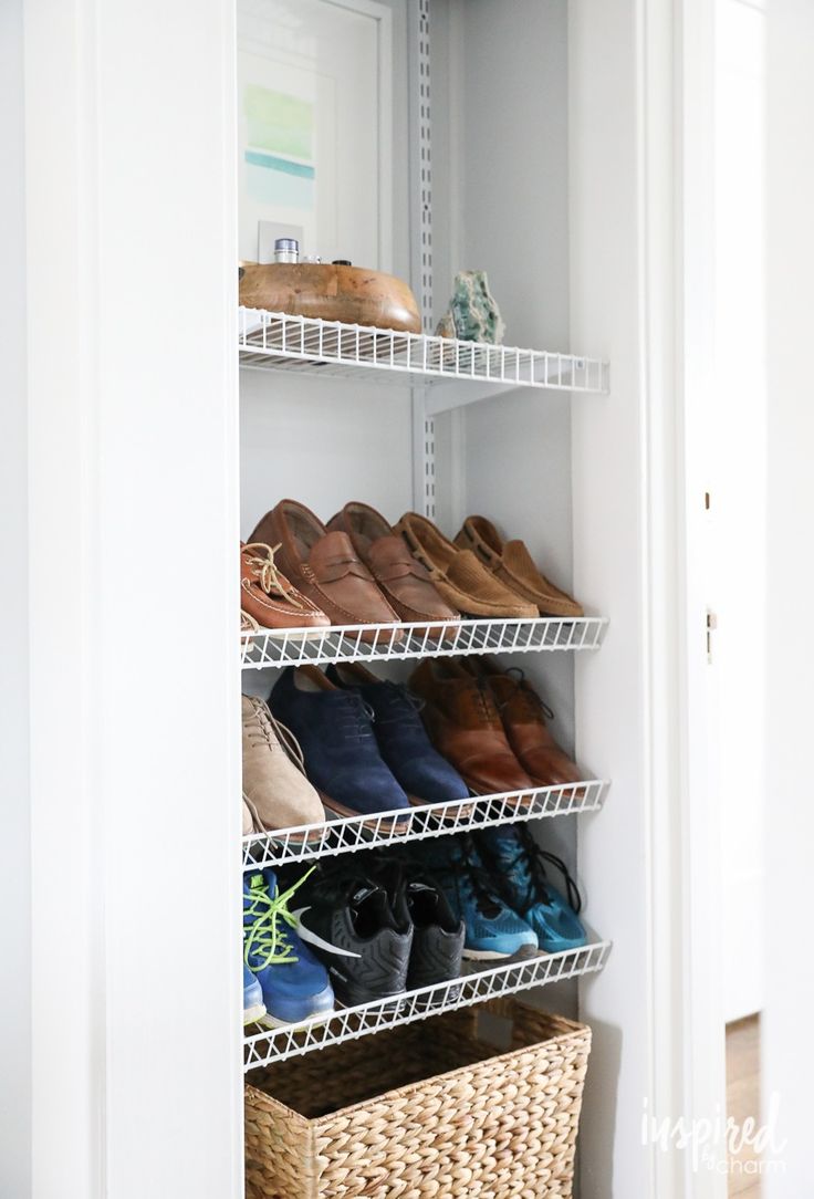 a white closet filled with lots of shoes and wicker baskets next to a door