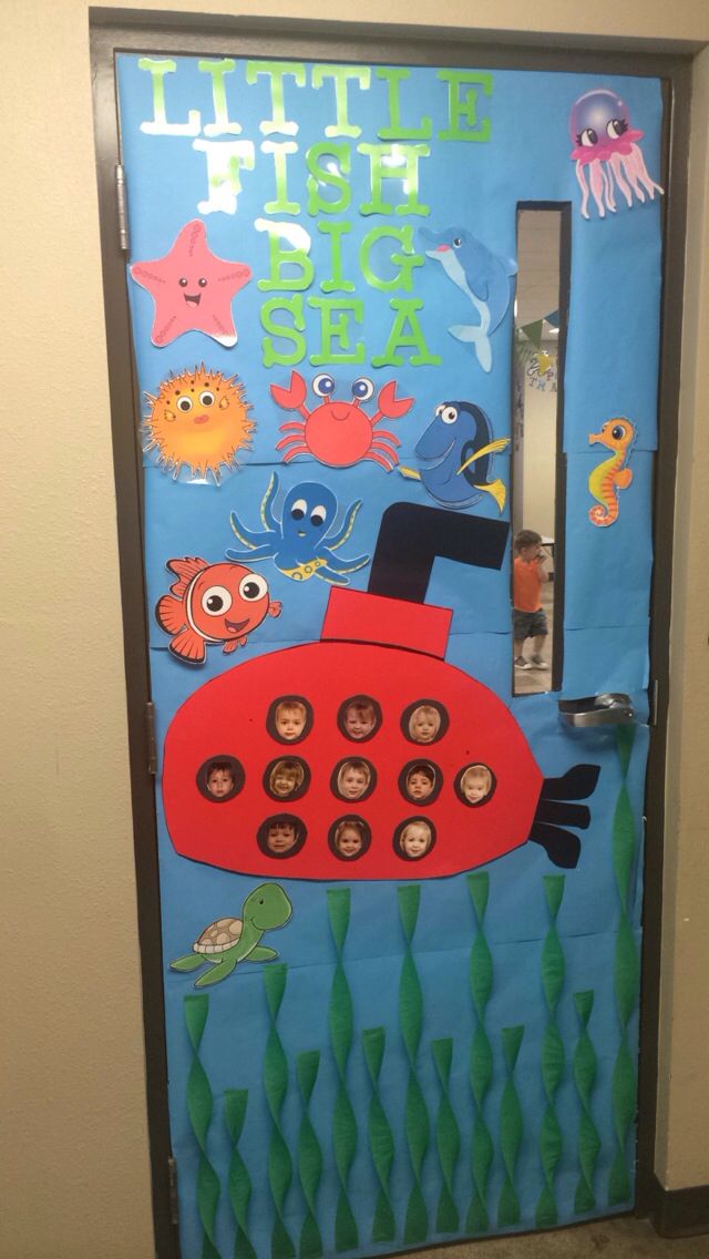 a door decorated with an image of a red submarine and sea animals on blue paper