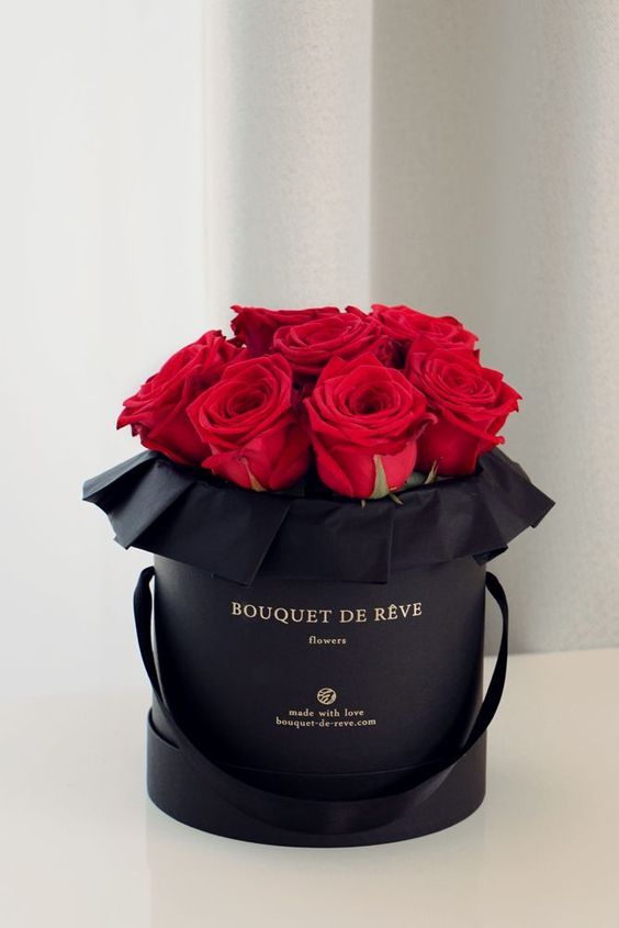 a black box with red roses in it