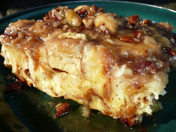 a close up of a piece of food on a plate with sauce and pecans