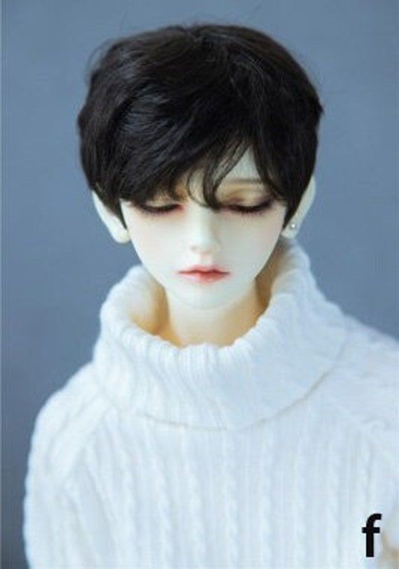 a mannequin head wearing a white sweater with black hair and eyeshades